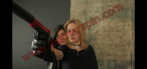 Girl with gun leather gloves leather pants boots